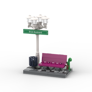 Weißer Laternenpfahl mit Bank - Grünes Schild